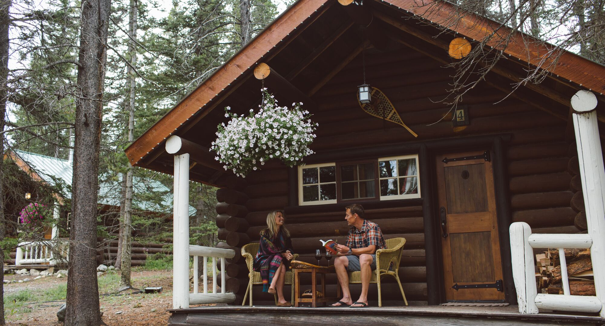 A couple enjoying a stay at a quaint mountain cabin in Banff National Park.